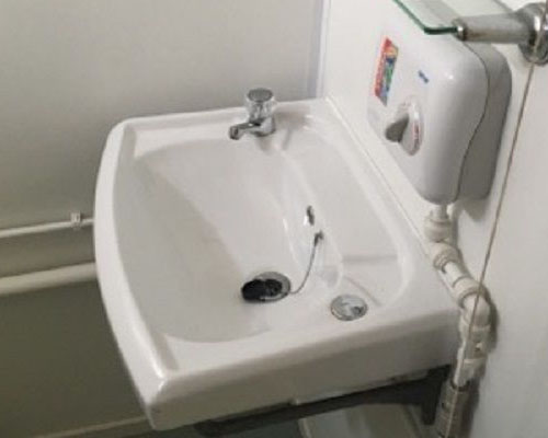 inside view of bathroom sink unit in the welfare unit container