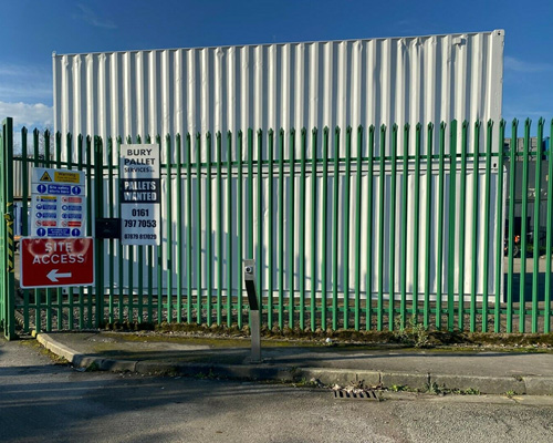 view of shipping container from behind the fence