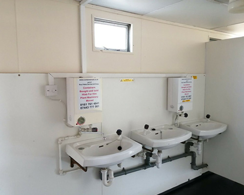 another inside view of the toilet unit showing 3 wash basins
